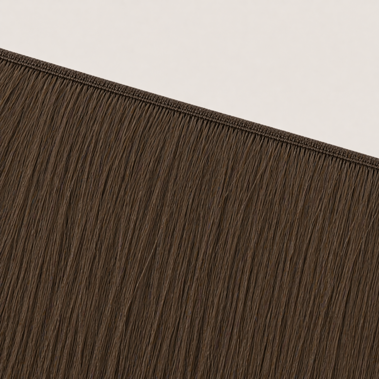 Flat butterfly weft seam of Stessia hair extensions in shade #4 Medium Brown