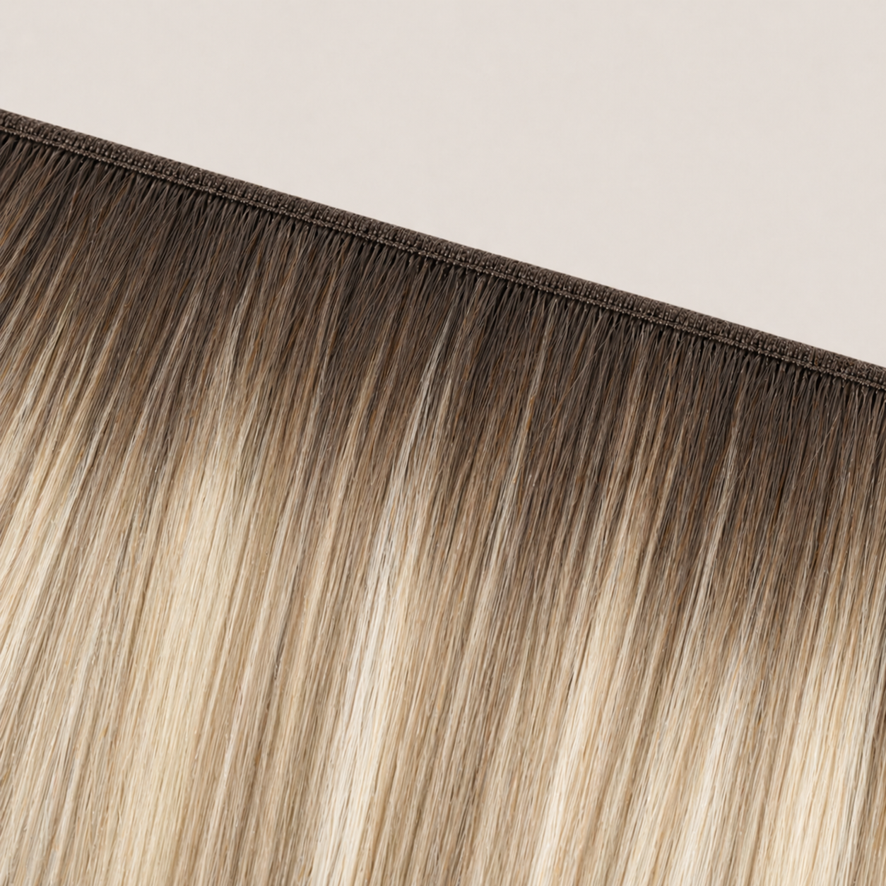 Flat butterfly weft seam of Stessia hair extensions in shade #5A/613/18 Balayage